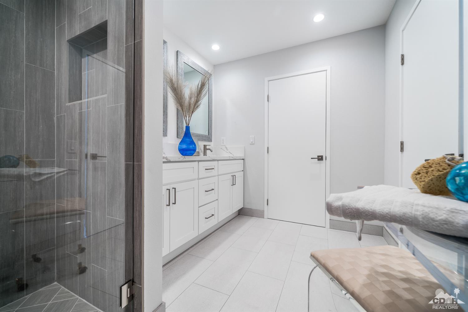 72845 Haystack Road Palm Desert, CA 92260 - Photo 26 of 39 a bathroom with a granite countertop sink a toilet and shower
