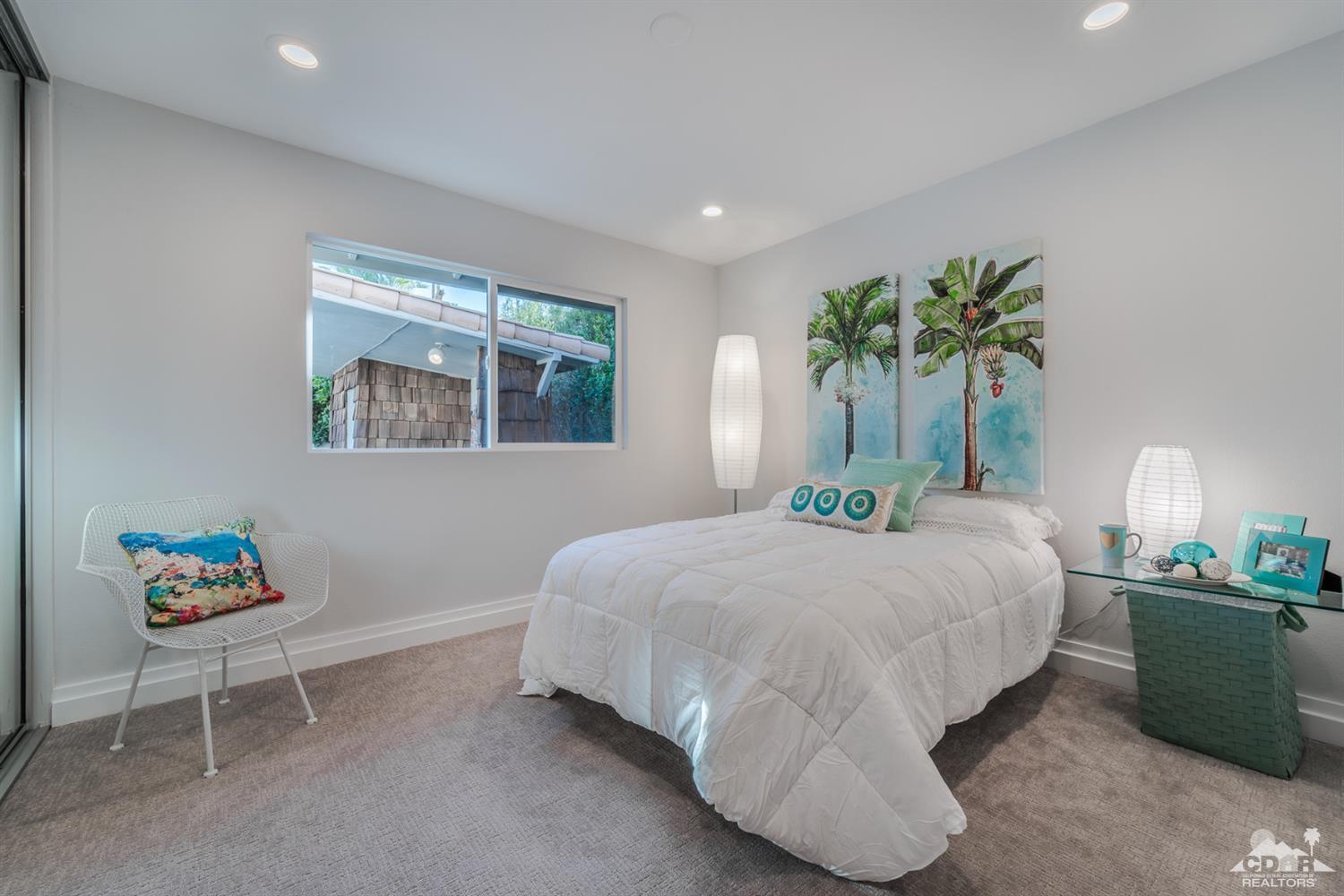 72845 Haystack Road Palm Desert, CA 92260 - Photo 27 of 39 a bedroom with a bed potted plant and a window