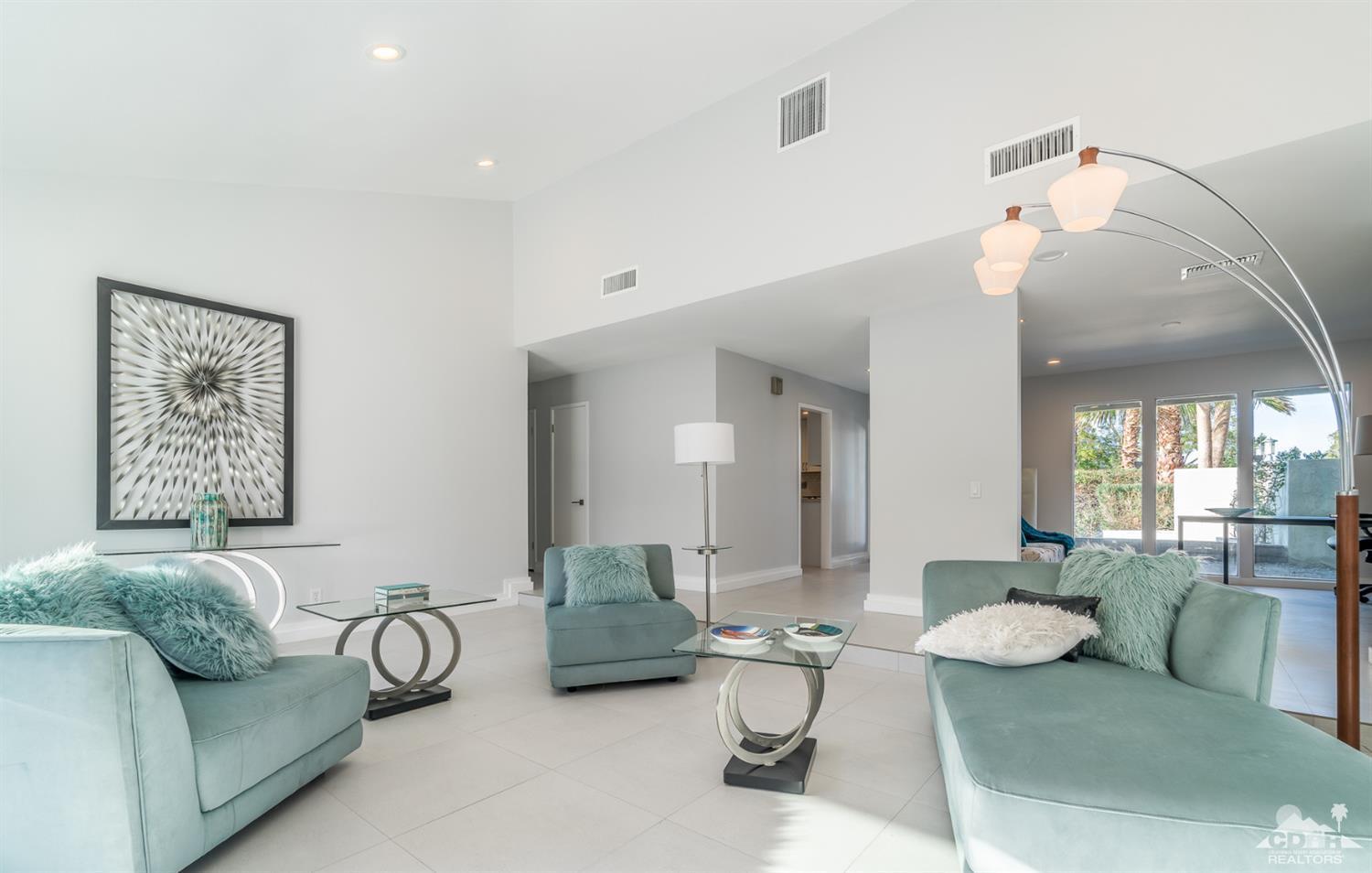 72845 Haystack Road Palm Desert, CA 92260 - Photo 4 of 39 a living room with furniture and a chandelier