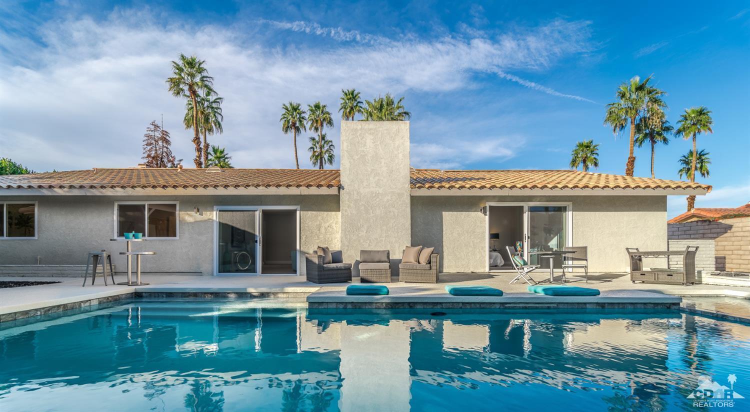 72845 Haystack Road Palm Desert, CA 92260 - Photo 34 of 39 a view of a patio with couches table and chairs with potted plants