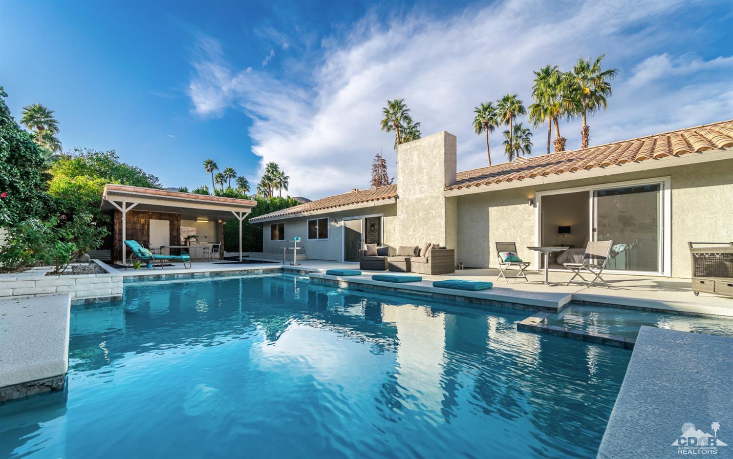 72845 Haystack Road Palm Desert, CA 92260 - Photo 35 of 39 a view of a swimming pool with couches chairs