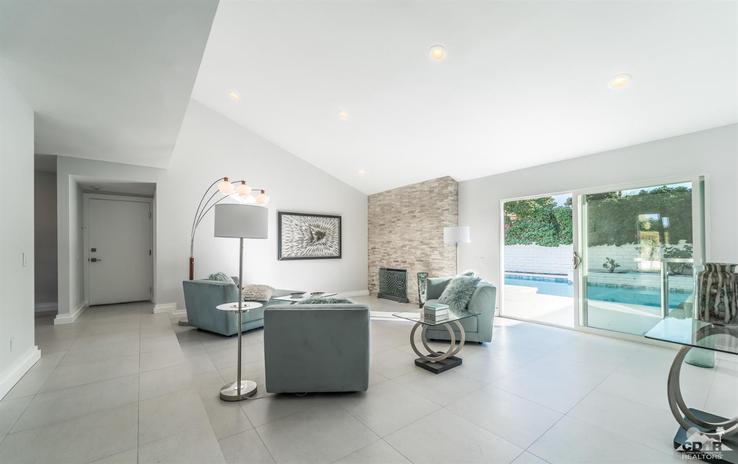 72845 Haystack Road Palm Desert, CA 92260 - Photo 7 of 39 a living room with furniture and a floor to ceiling window