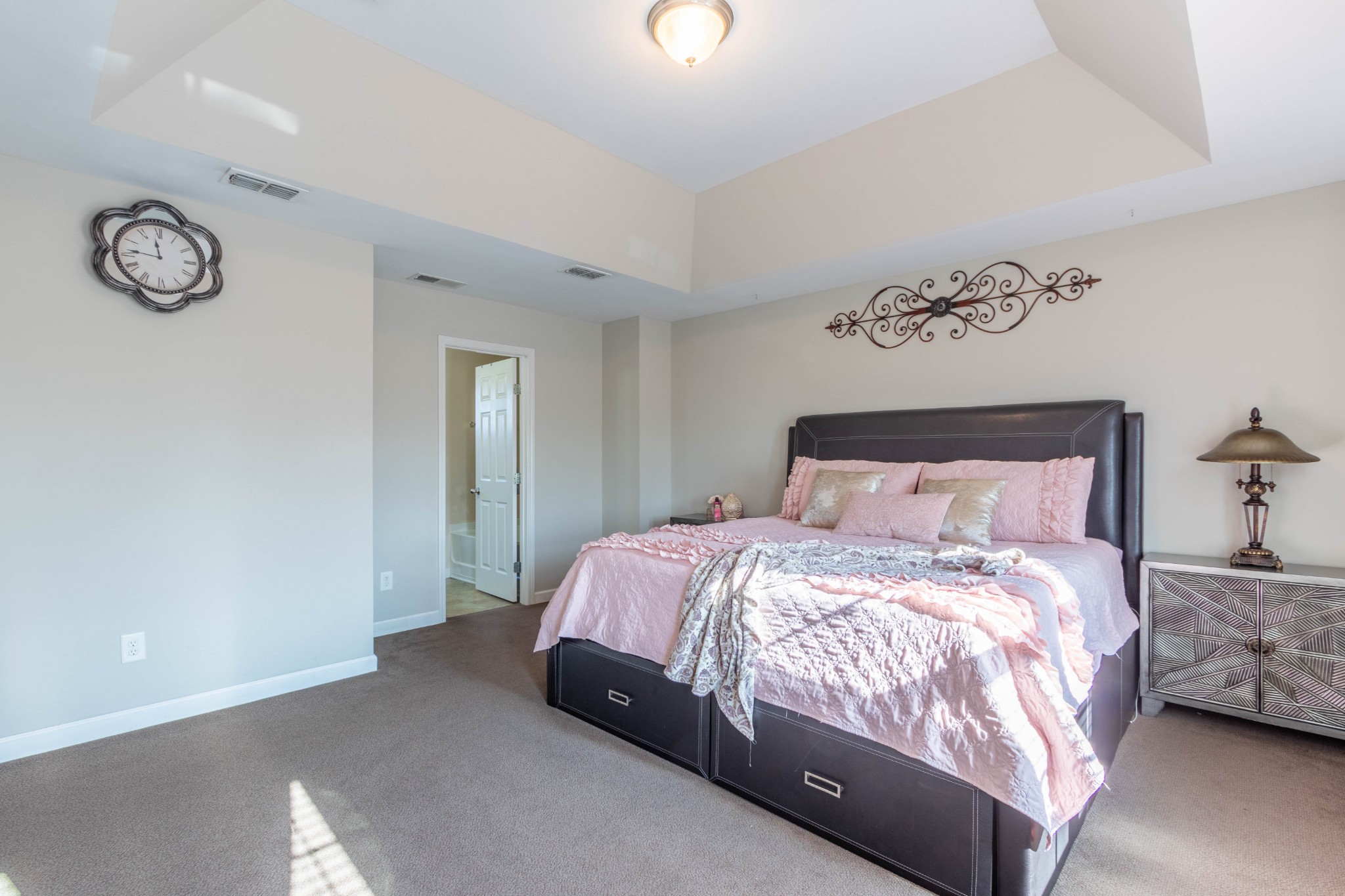 6017 Cane Springs Road Antioch, TN 37013 - Photo 24 of 35 a large bed sitting in a bedroom next to a window and a chandelier