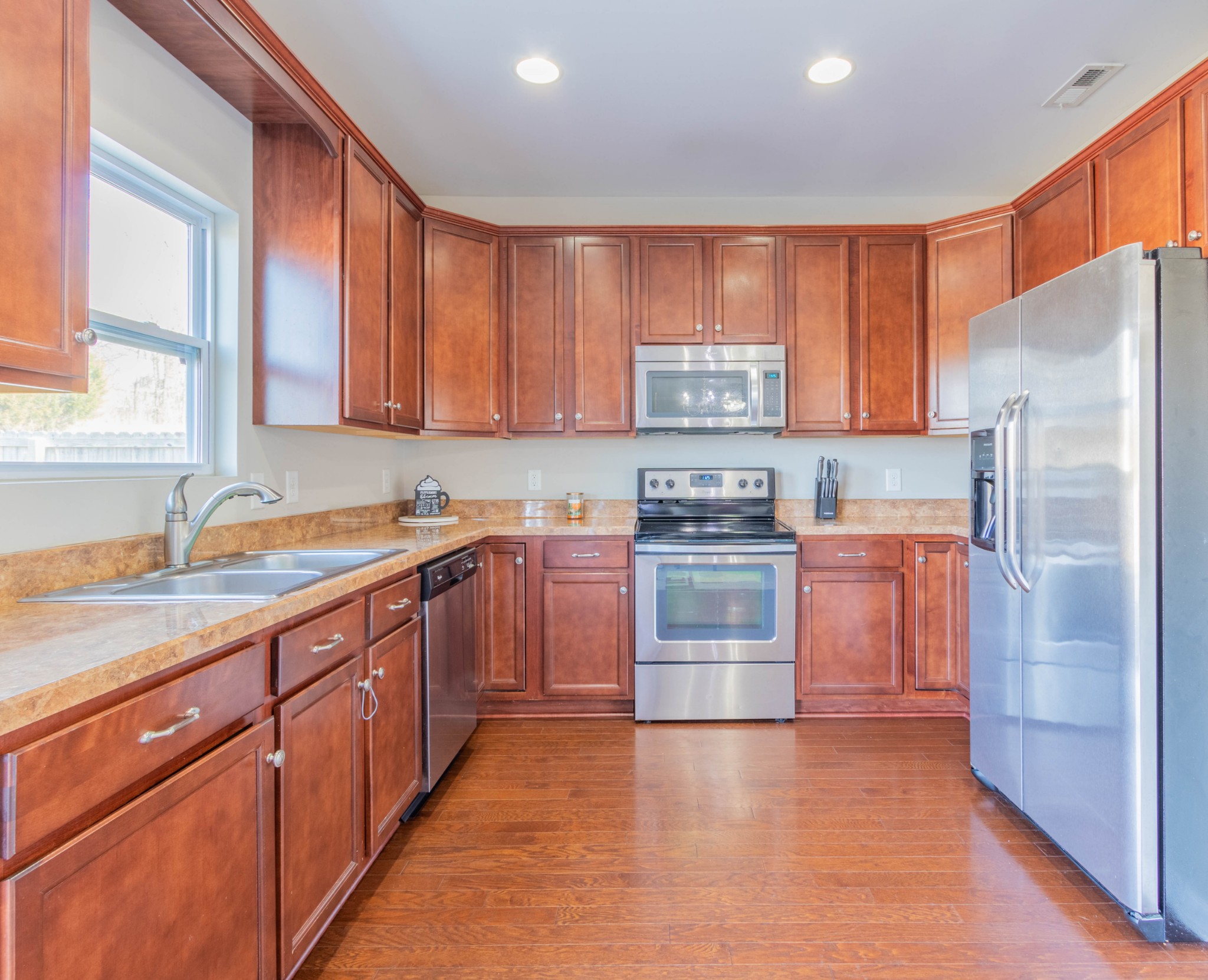 6017 Cane Springs Road Antioch, TN 37013 - Photo 10 of 35 a kitchen with stainless steel appliances granite countertop a refrigerator and a sink