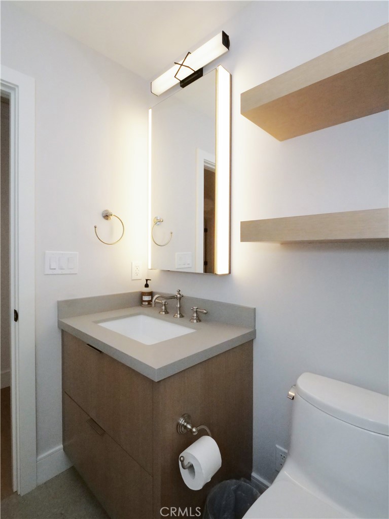2 Flying Mane Road Rolling Hills, CA 90274 - Photo 25 of 49 a bathroom with a toilet sink vanity and mirror