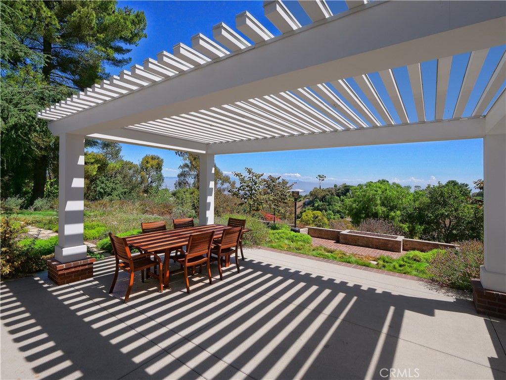 2 Flying Mane Road Rolling Hills, CA 90274 - Photo 41 of 49 a view of a patio with table and chairs potted plants with wooden floor and fence