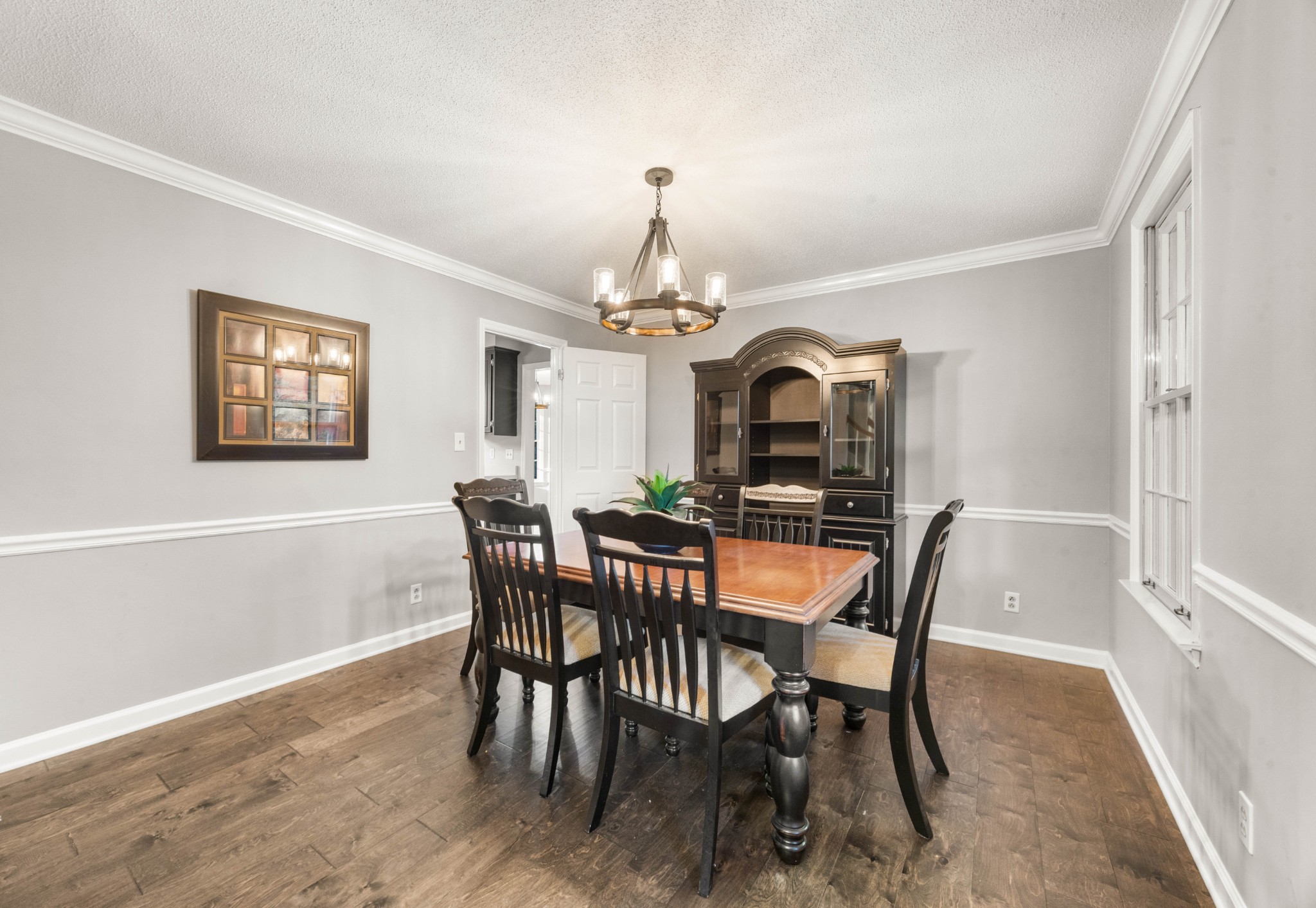 407 Idaho Springs Road Clarksville, TN 37043 - Photo 18 of 45 a dining room with furniture a chandelier and wooden floor