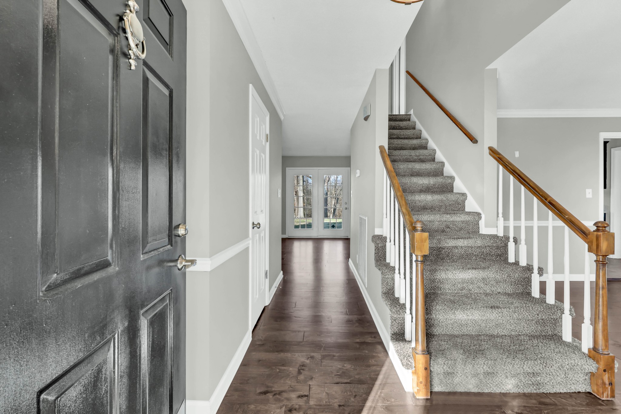 407 Idaho Springs Road Clarksville, TN 37043 - Photo 5 of 45 a view of staircase with lots of frames on wall and wooden floor