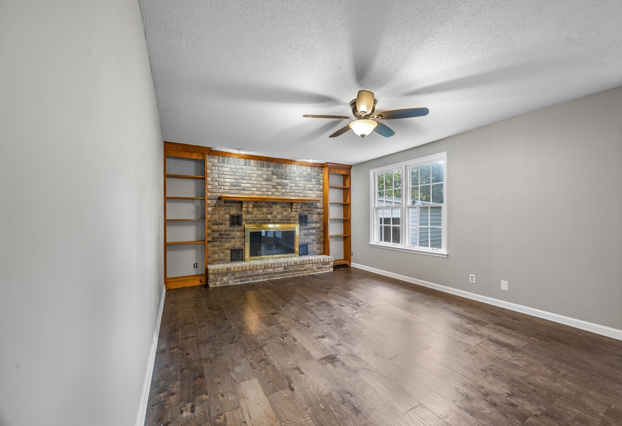 407 Idaho Springs Road Clarksville, TN 37043 - Photo 9 of 45 an empty room with windows chandelier fan and windows