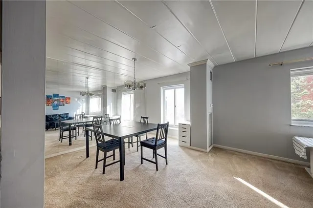 a view of a dining room with furniture and window