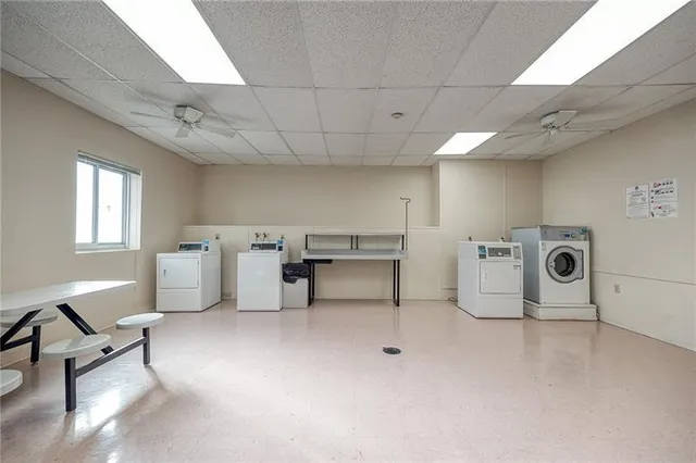 a view of a storage & utility room with two washing machine