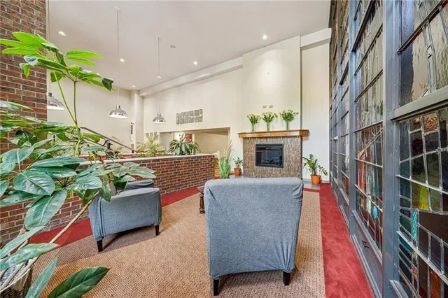 a living room with patio furniture and a fireplace