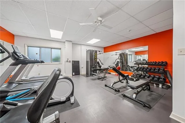 a room with gym equipment and large mirror