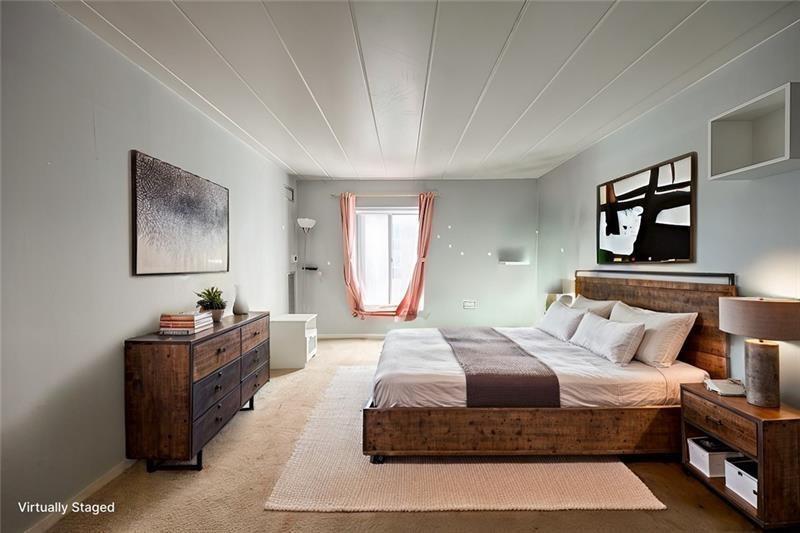 5 Bayard Road, Unit 309 Pittsburgh, PA 15213 - Photo 5 of 22 a bedroom with a large bed and a chandelier