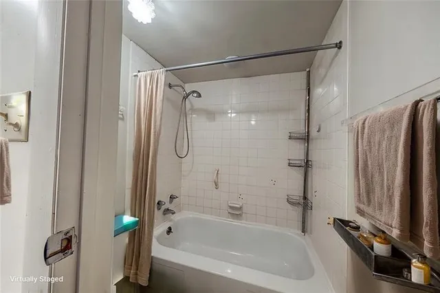 a bathroom with a shower and a bathtub