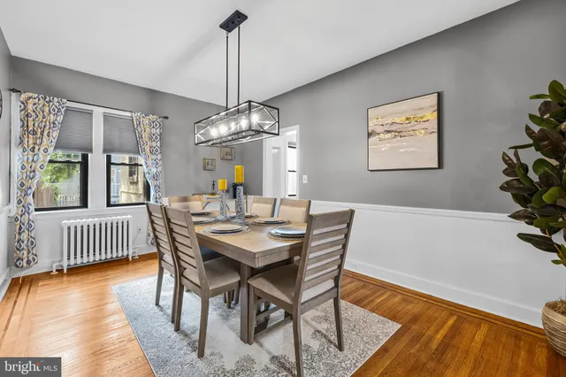 a view of a dining room with furniture wooden floor and chandelier