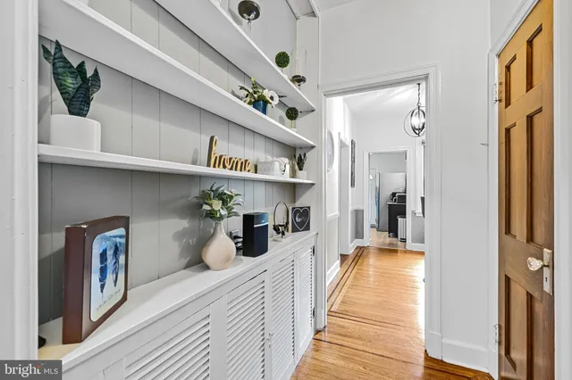 a hallway with wooden cabinets