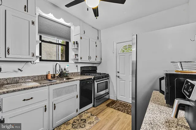 a kitchen with sink cabinets and stainless steel appliances