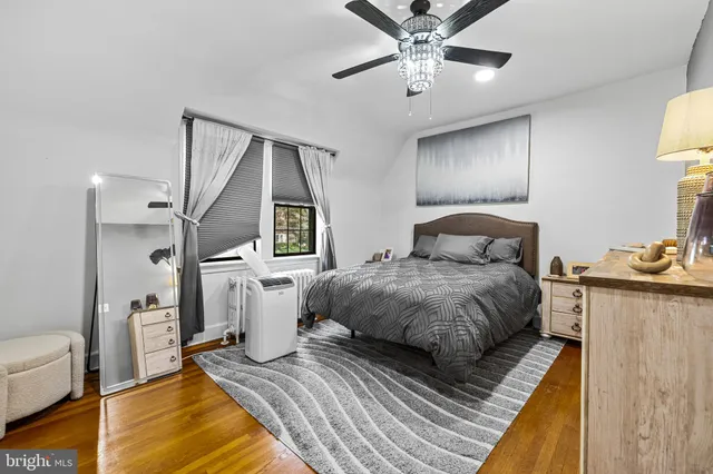 a spacious bedroom with a bed and a chandelier
