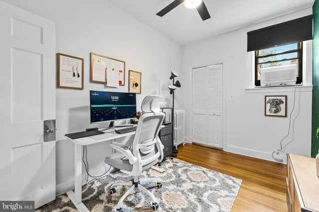 a bedroom with furniture and a flat screen tv