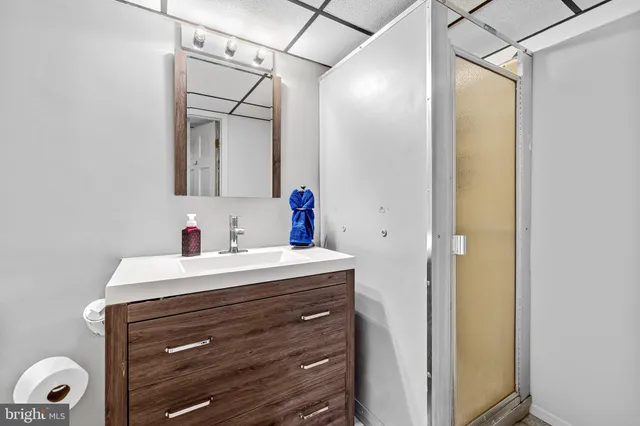 a bathroom with a sink vanity and a mirror