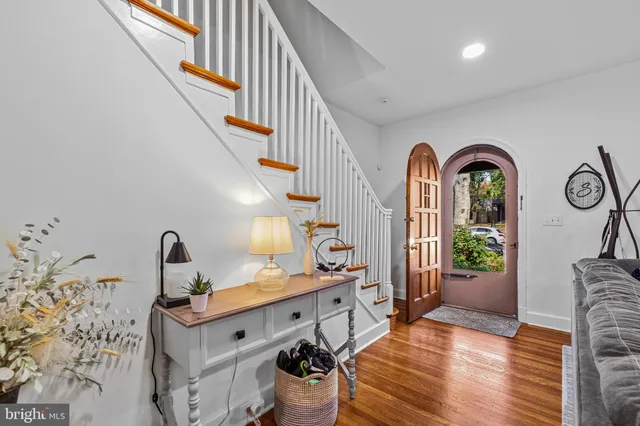 a view of living room kitchen and entryway