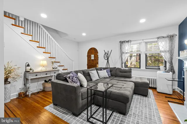 a living room with furniture fireplace and a table