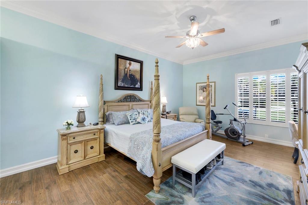 11426 Quail Village Way Naples, FL 34119 - Photo 14 of 46 a bedroom with a bed and a chair in it