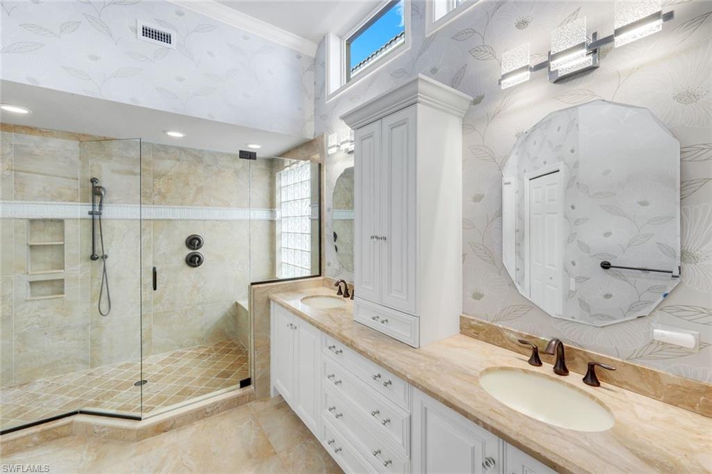 11426 Quail Village Way Naples, FL 34119 - Photo 16 of 46 a bathroom with a granite countertop double vanity sink mirror and shower