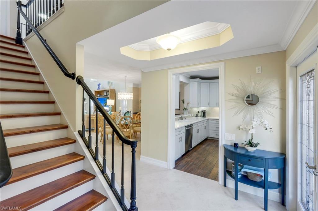 11426 Quail Village Way Naples, FL 34119 - Photo 18 of 46 a view of a hallway with furniture and entryway