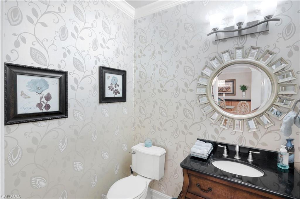 11426 Quail Village Way Naples, FL 34119 - Photo 19 of 46 a bathroom with a toilet and a sink