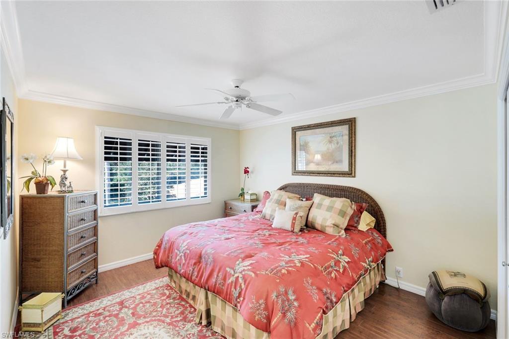 11426 Quail Village Way Naples, FL 34119 - Photo 23 of 46 a bedroom with a large bed and a window