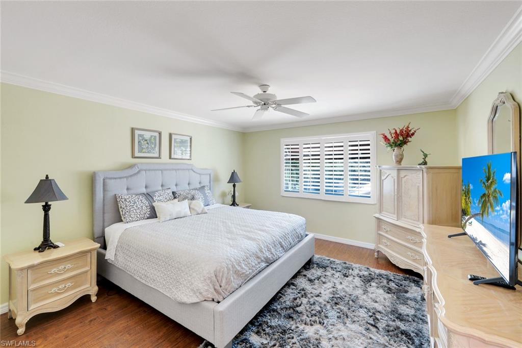 11426 Quail Village Way Naples, FL 34119 - Photo 25 of 46 a bedroom with a bed dresser and a window