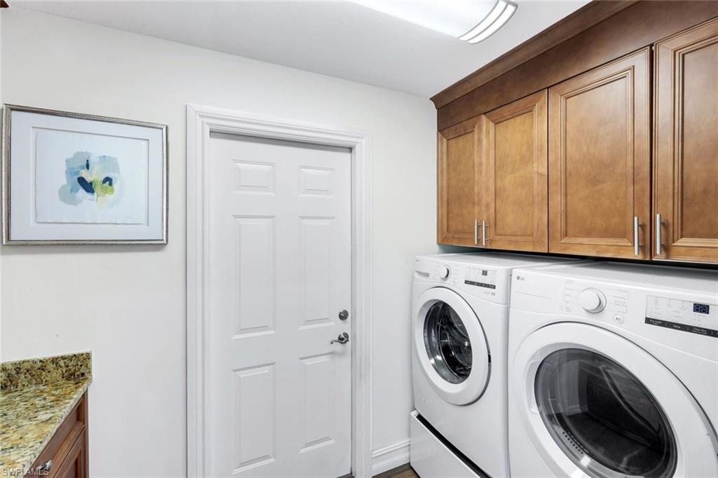 11426 Quail Village Way Naples, FL 34119 - Photo 28 of 46 a view of a hallway with washer and dryer