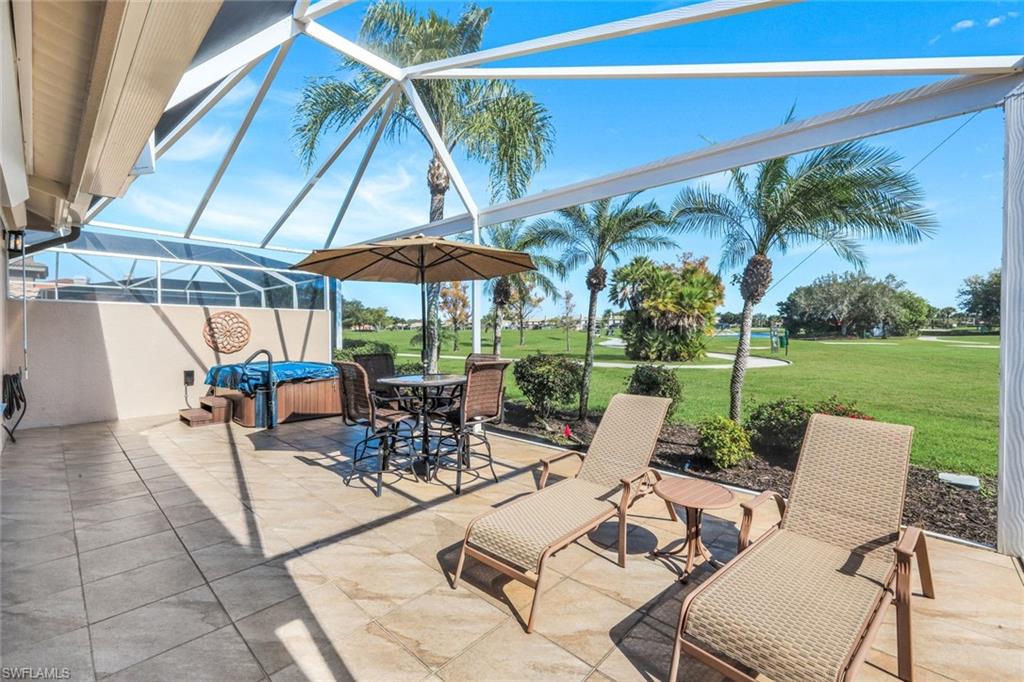 11426 Quail Village Way Naples, FL 34119 - Photo 30 of 46 a view of chairs and tables in a yard
