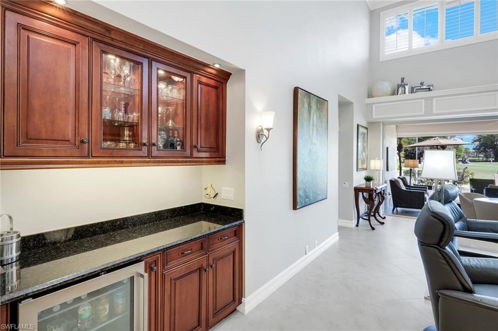 11426 Quail Village Way Naples, FL 34119 - Photo 5 of 46 a kitchen with stainless steel appliances granite countertop a stove and cabinets