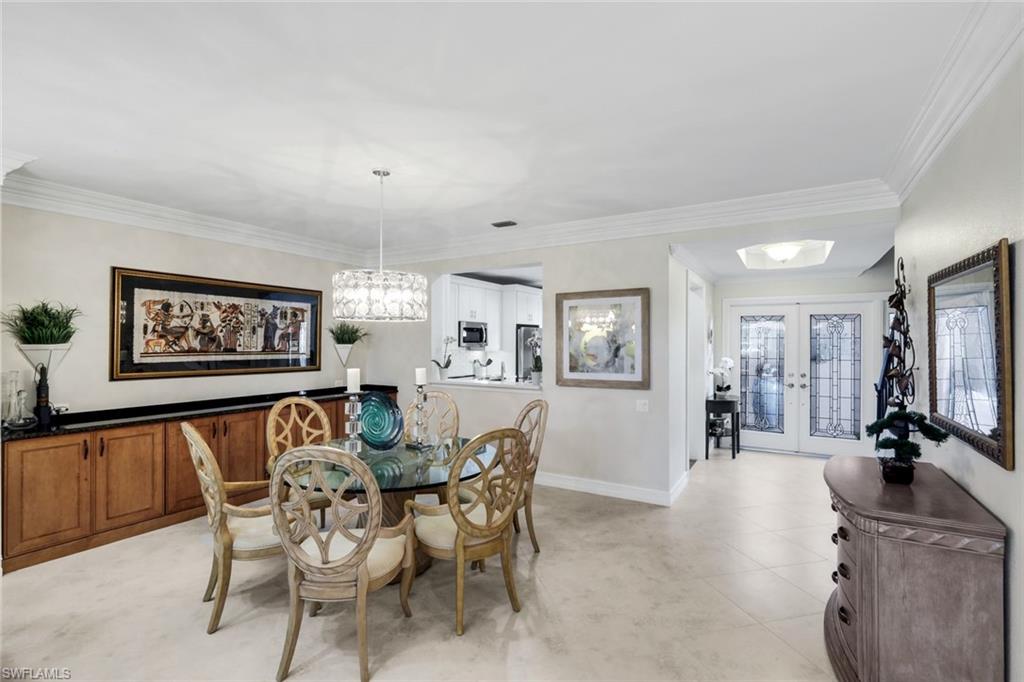11426 Quail Village Way Naples, FL 34119 - Photo 8 of 46 a view of a dining room with furniture