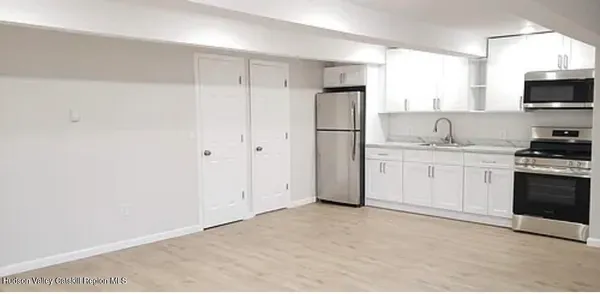 a kitchen with a sink a refrigerator and a stove top oven