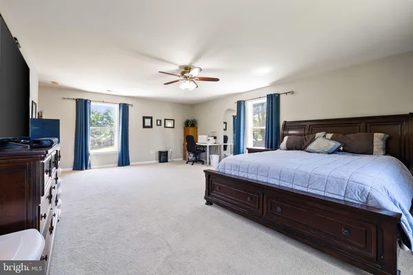 a large bedroom with a bed and a dresser