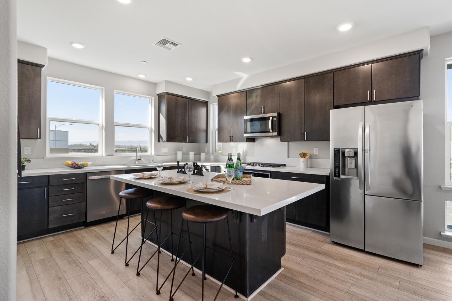 495 Snap Dragon Street Milpitas, CA 95035 - Photo 11 of 33 a kitchen with a sink a kitchen island stainless steel appliances cabinets and a window