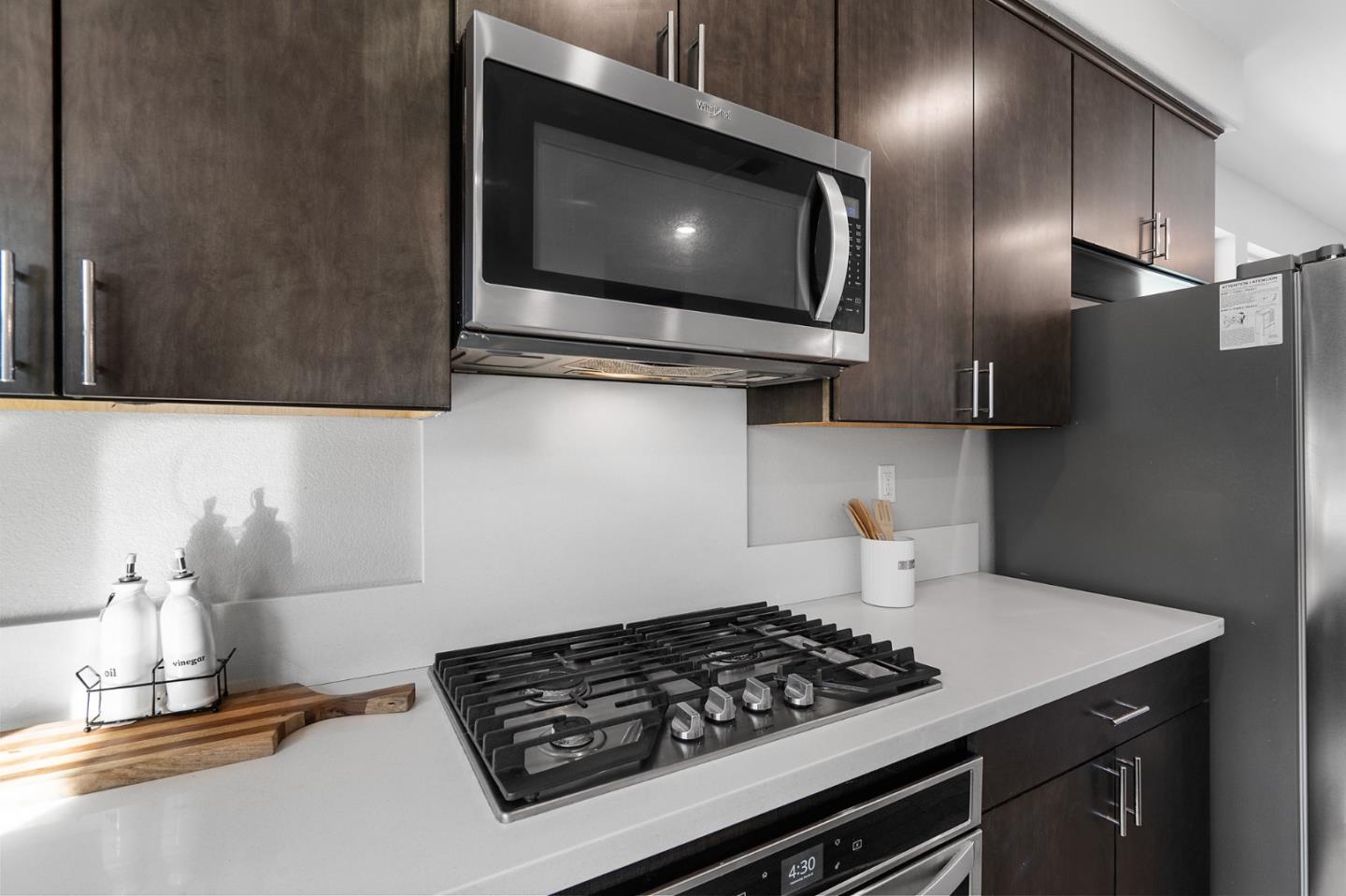 495 Snap Dragon Street Milpitas, CA 95035 - Photo 14 of 33 a kitchen with stainless steel appliances a stove and a microwave