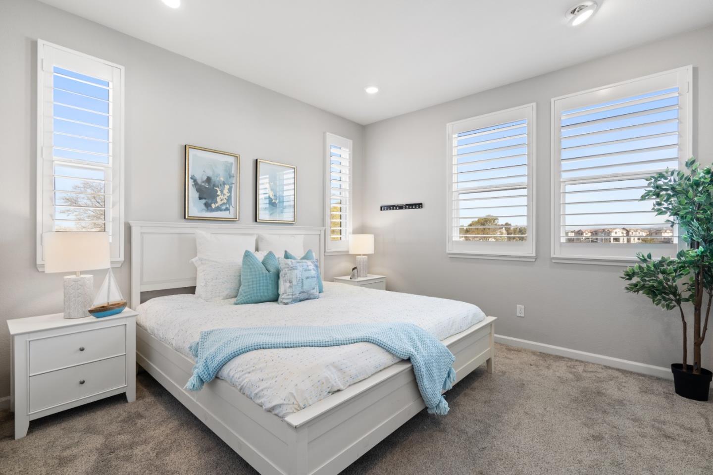 495 Snap Dragon Street Milpitas, CA 95035 - Photo 19 of 33 a bedroom with a large bed and a potted plant