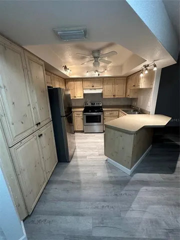 a kitchen with refrigerator and microwave