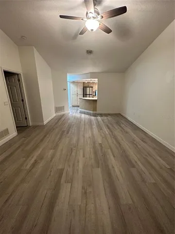 a view of wooden floor and windows in a room