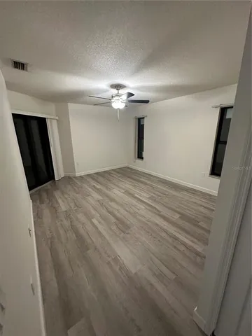 a view of a livingroom with a ceiling fan and window