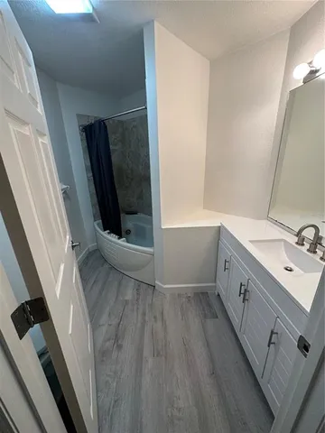 a bathroom with a sink a mirror and a shower