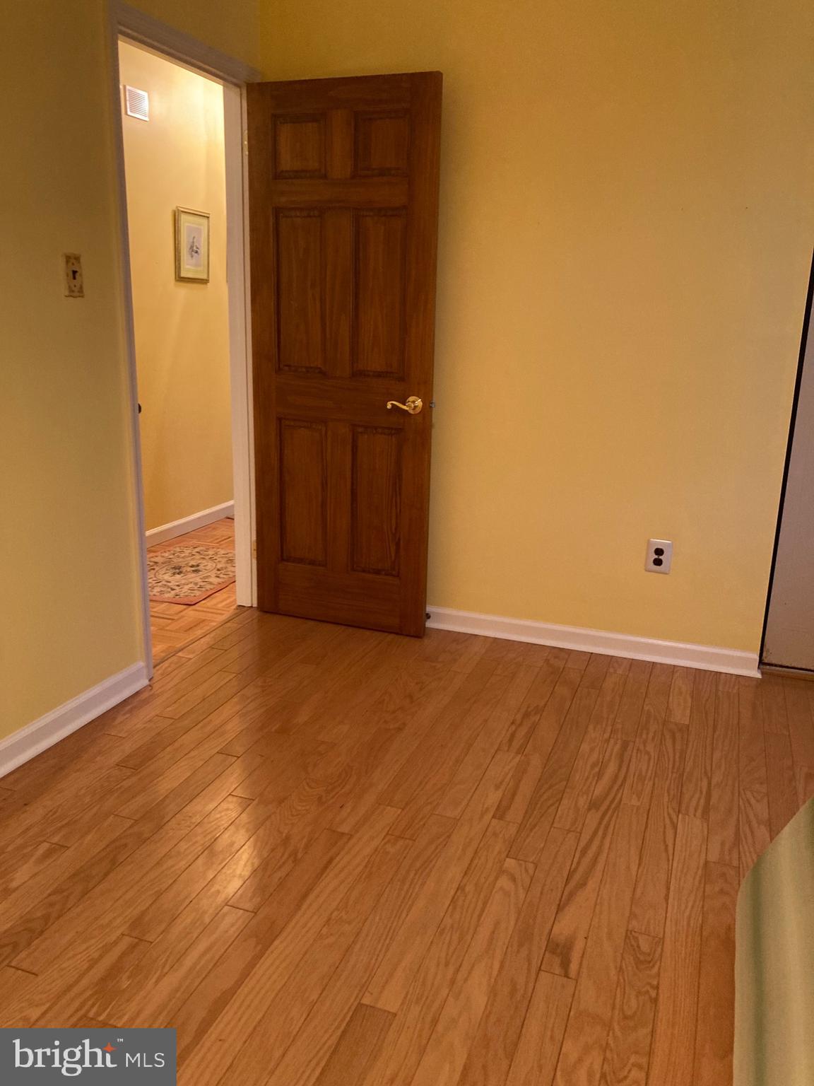 421 Lakeview Terrace Pemberton, NJ 08068 - Photo 18 of 23 an empty room with wooden floor and cabinet