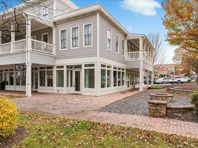 a front view of a building with a garden