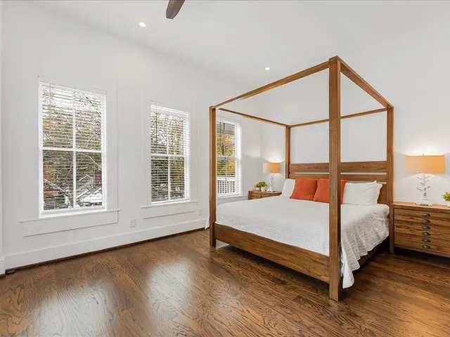 a bedroom with a bed and a large window