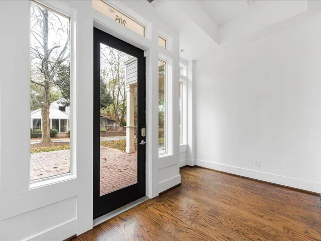 a view of an entryway with wooden floor and door